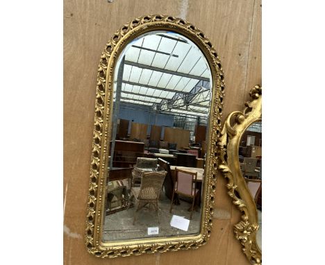 AN ARCHED GILT FRAMED MIRROR 