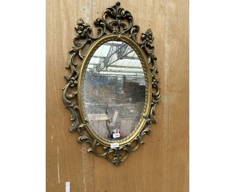 AN ARCHED GILT FRAMED MIRROR 
