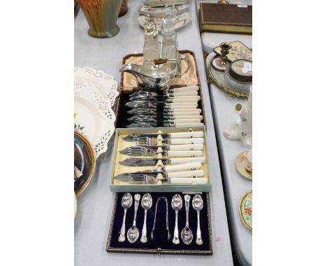 THREE VINTAGE BOXED SETS OF FLATWARE, A WALKER AND HALL STAINLESS STEEL JUG AND A GLASS CONDIMENT SET WITH A STAND 
