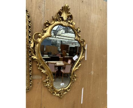 AN ORNATE GILT FRAMED MIRROR 