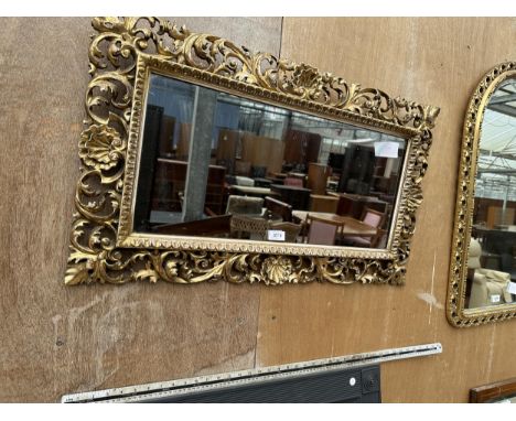 AN ORNATE GILT FRAMED MIRROR 