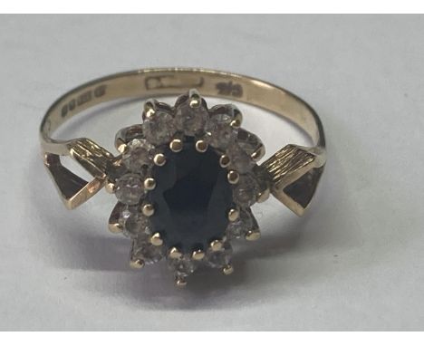 A 9 CARAT GOLD RING WITH SAPPHIRE AND CUBIC ZIRCONIAS 