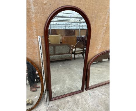 AN ARCHED MAHOGANY MIRROR 