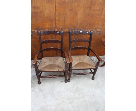 A PAIR OF 18TH CENTURY STYLE LOW OAK LADDER-BACK ELBOW CHAIRS WITH RUSH SEATS 