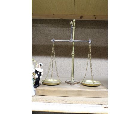 A SET OF BRASS BALANCE SCALES ON A WOODEN BASE 
