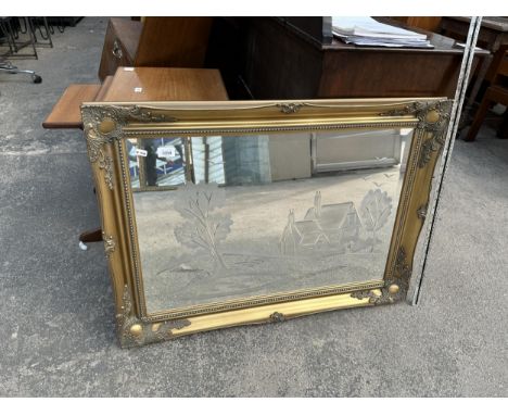 AN ORNATE RECTANGULAR GILT FRAMED MIRROR 