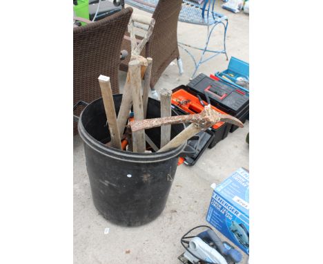 A PLASTIC BIN WITH AN ASSORTMENT OF TOOLS TO INCLUDE A PICK AXE AND A SHOVEL ETC 