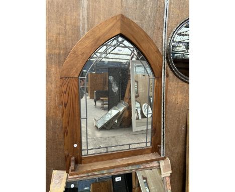 AN OAK ARCH FRAMED MIRROR WITH LOWER SHELF 