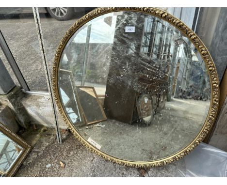 A 32" DIAMETER CIRCULAR GILT FRAMED WALL MIRROR 