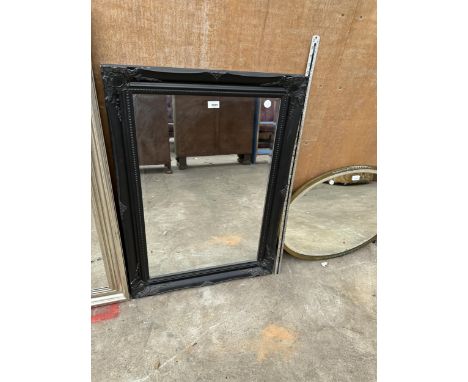 A RECTANGULAR BLACK FRAMED MIRROR 
