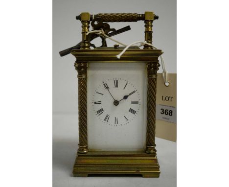 A French late 19th/early 20th Century brass-cased carriage clock, roman dial within a glazed brass case, turned covered suppo