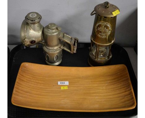 An Eccles brass miner's lamp; together with a Powell &amp; Hanmer 'New Sultan' cycle lamp; and a Norwegian wooden tray. (3)