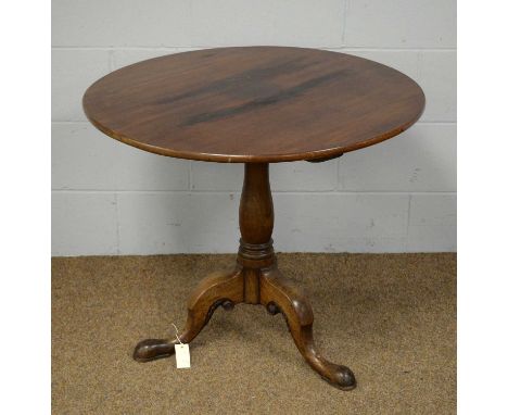 A late 19th Century mahogany tilt-top tripod table, the circular top above a central turned column, raised on hip and outswep