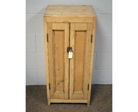 A 19th Century stripped pine cupboard, the caddy top above two panelled doors with brass catch, enclosing three open shelves,
