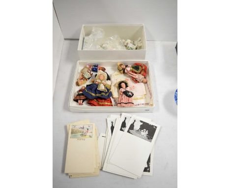 A selection of collectables, including: vintage menu cards; various dolls, each in traditional dress; a set of three Dresden 