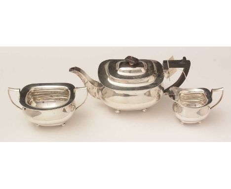 A George V silver three-piece tea service, by William Hutton and Sons, Sheffield, 1927, with an engraved monogram and date, 3