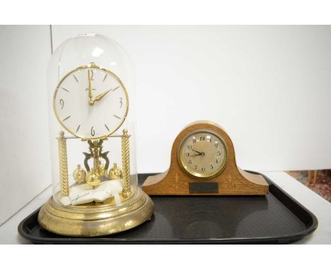 An Edwardian inlaid oak mantel clock, of small proportions, the domed case with presentation plaque to obverse, raised on bun