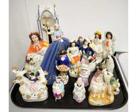 A collection of Staffordshire figures and figure groups; together with a pair of nodding figures and a teapot cosy with ceram