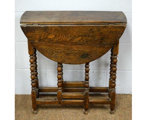 A 19th Century oak gateleg table of small proportions, the rectangular top with two drop leaves, raised on bobbin turned supp