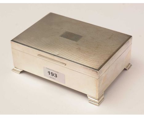 An Elizabeth II silver table cigarette box, by Francis Howard Ltd, Birmingham, 1973, with engine-turned cover and a vacant ca