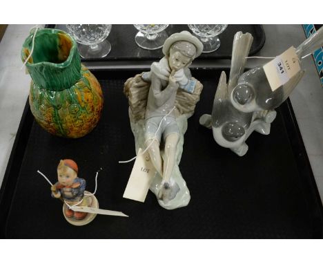 A Lladro figure of a boy, modelled lying against a tree stump; together with a Lladro figure group of love birds; Hummel figu