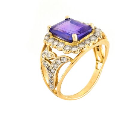 Vintage Emerald Cut Tanzanite, Diamond and 14 Karat Yellow Gold Ring. Tanzanite measures 10mm x 7mm.&nbsp;Tanzanite has a gre