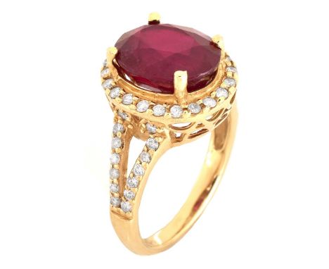 Glass Filled Oval Cut Ruby, Diamond and 14 Karat Yellow Gold Ring. Ruby with vivid color, measures 11mm x 9mm. Stamped 14K. A