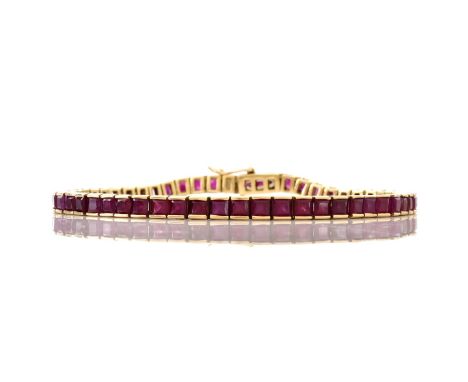 Vintage Square Cut Ruby and 14 Karat Yellow Gold Line Bracelet. Rubies with vivid color. Unsigned. Measures 7-1/4" L, 1/8" W.