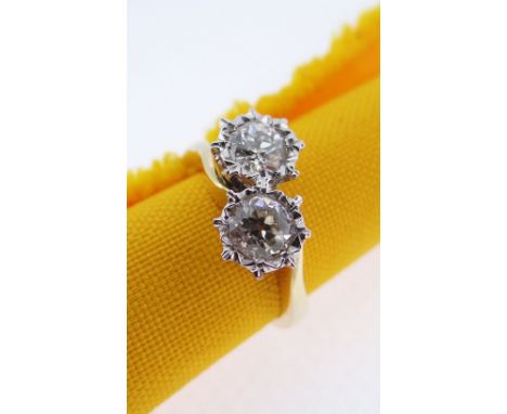 18CT GOLD TWO STONE DIAMOND RING, the two primary stones (totalling 0.7cts approximately) illusion set on a twist shank, ring