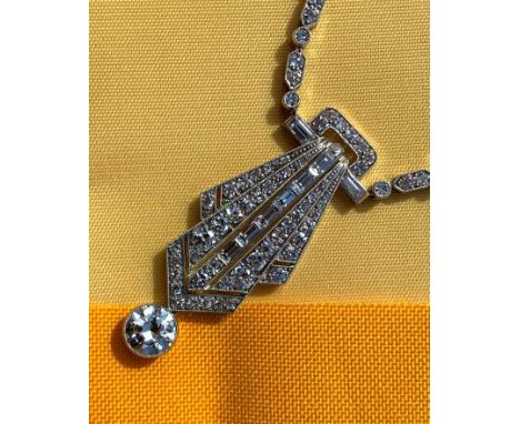 ART DECO DIAMOND ENCRUSTED PENDANT ON CHAIN, having diamond drop (1.0ct approx.) below the pierced geometric fan shaped penda