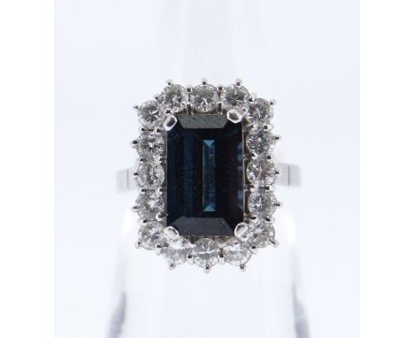 18CT WHITE GOLD SAPPHIRE &amp; DIAMOND CLUSTER RING, the central sapphire (10 x 6mms) surrounded by sixteen diamonds (0.05cts