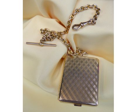 9CT GOLD ENGINE TURNED VESTA CASE of rectangular shape with 9ct gold oval link Albert chain with 'T-bar', the chain 33.5cms l
