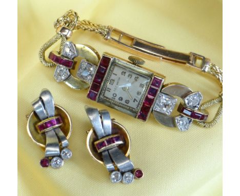 YELLOW METAL DIAMOND &amp; RUBY SET COCKTAIL WATCH, the dial marked 'A E C Watch', set with a border of square cut rubies, ac