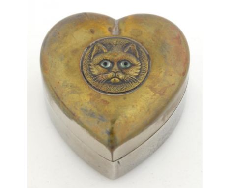 A PLATED BRASS HEART SHAPED TRINKET BOX, THE COVER EMBOSSED WITH THE HEAD OF A GLASS EYED CAT, 7.5CM W, C1900
