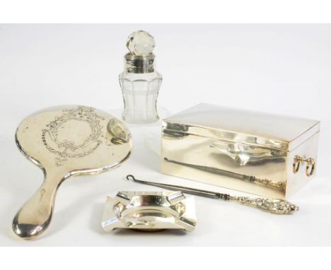 A SILVER HAND MIRROR, MARKS RUBBED, A SILVER ASHTRAY, A SILVER MOUNTED JAR, WITH STOPPER, A SILVER HANDLED BUTTON HOOK AND A 