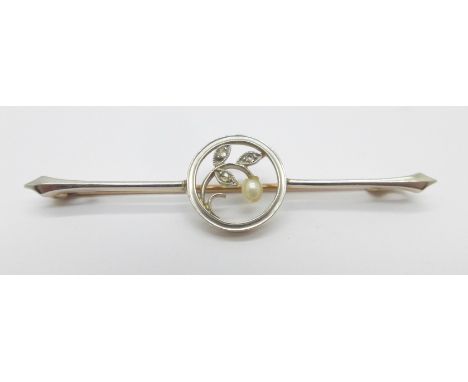 An early 20th Century Art Nouveau 15ct gold and platinum set pin brooch with three old cut diamonds and one seed pearl, 3.3g 