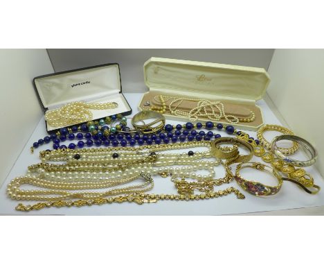 A collection of bangles and faux pearl necklaces, etc. 