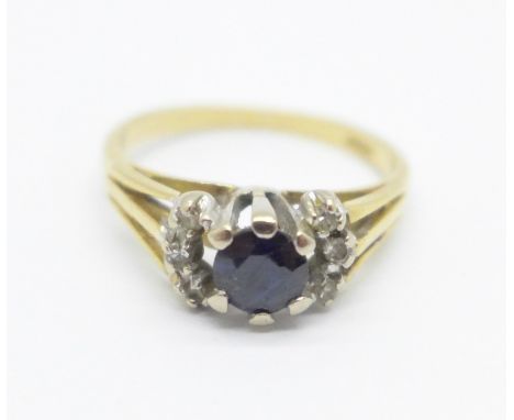 An 18ct gold ring set with blue central stone with six diamonds, 2.8g, K 