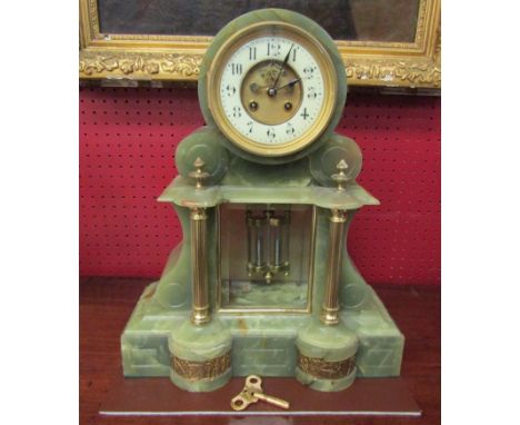 A late Victorian onyx French mantel clock, two train movement with exposed escapement and mercury compensating pendulum, with
