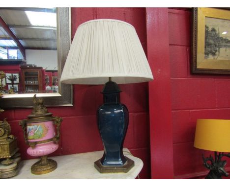 A pair of deep blue and gilt ceramic table lamps with peated shades