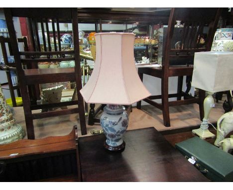 A table lamp depicting birds on branches, with shade
