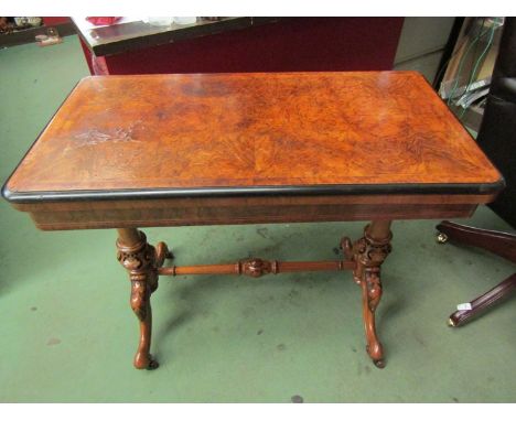 Stamped "Maple &amp; Co" a burr walnut circa 1860 card table on turned and carved base with ceramic castors