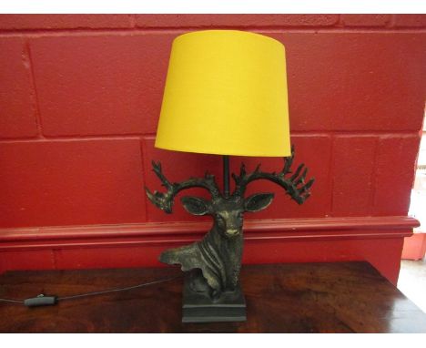 A stag head table lamp with shade