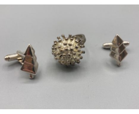 A silver starburst ring 8.6g size P and a pair of white metal cufflinks 6.2g