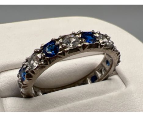 Ladies 18ct white gold blue and white stone full eternity ring. Comprising of 9 blue stones and 9 cz stones. Size M 3.8g