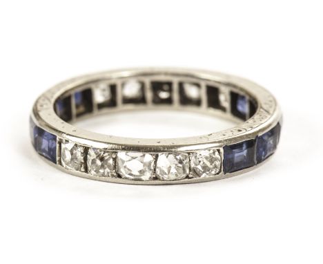 A vintage sapphire and diamond full eternity ring, having two sets of five cut blue stones and old cushion cuts set in white 