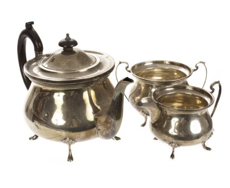 A George V silver three piece tea set by WA, the squat form vessels on four pad feet supports, comprising tea pot, milk jug a