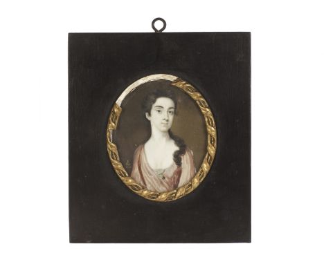 A George I portrait miniature, possibly on vellum, of a gentleman’s sweetheart, picked out in gilt and with gilt monogram and