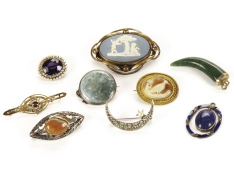 A collection of pendants and brooches, including a Ruskin style pottery brooch, a pretty lapis lazuli and enamel pendant, a j