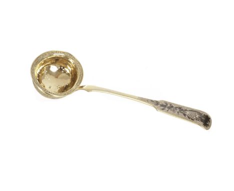 An early 19th century Russian silver gilt and niello sauce ladle, silver marks for Nikolay Bubrovin 1827, and decorated with 